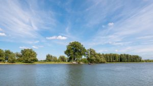 Panorama of river Afgedamde Maas with ferry boat near Woudrichem, Netherlands
